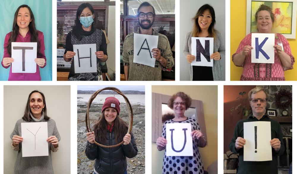 people holding letters to spell out thank you