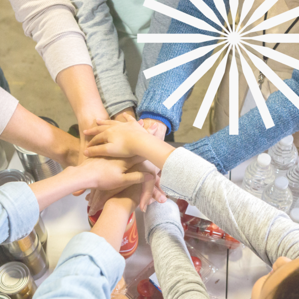 A group of people holding stacking hands together.